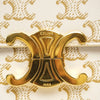 SLG Luxury CELINE Triomphe shoulder bag featuring a white coated canvas with gold monogram and gold-tone metal clasp.