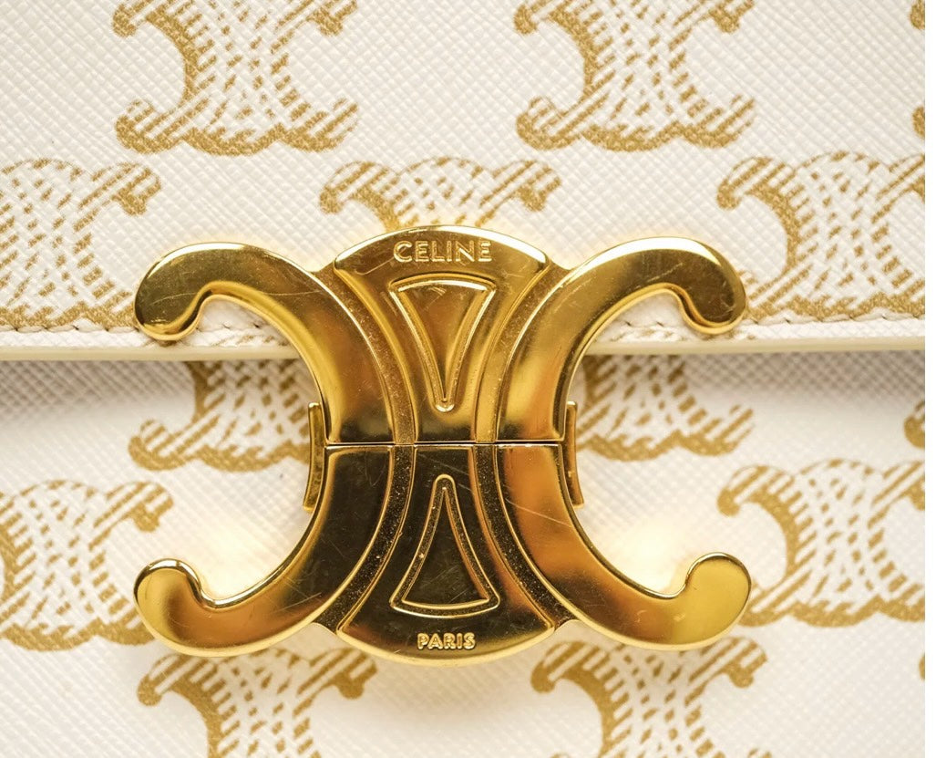 SLG Luxury CELINE Triomphe shoulder bag featuring a white coated canvas with gold monogram and gold-tone metal clasp.