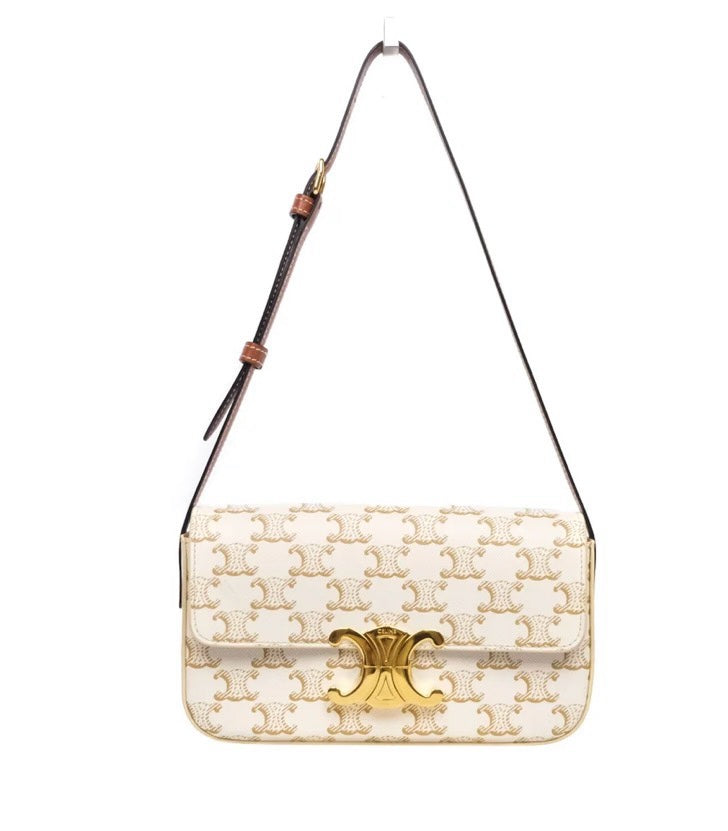 SLG Luxury CELINE Triomphe shoulder bag in white coated canvas with gold monogram print and gold-tone metal clasp.